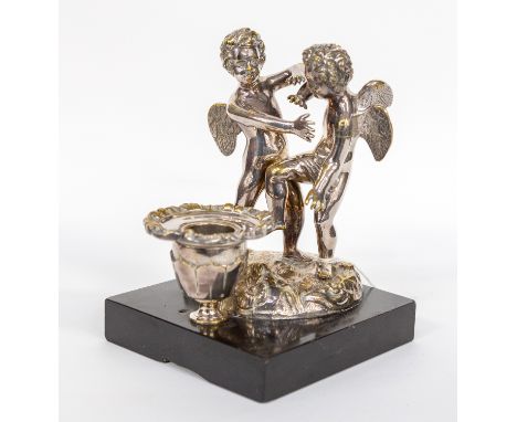 Chamber stick, depicting two winged cherubs, standing on a marble base