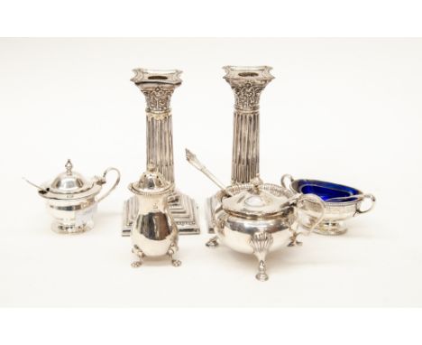A pair of Birmingham silver 1900 candlesticks, two mustard pots, a salt condiment dish, a pepper and three caddy spoons, all 