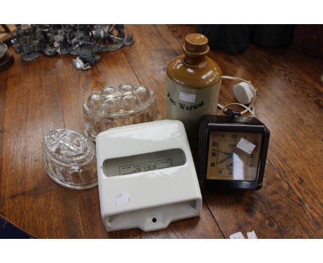 A Bakelite "Ferranti" Art Deco electric clock, alarm, a stoneware footwarmer, a ceramic Jeyes antiseptic paper dispenser and 