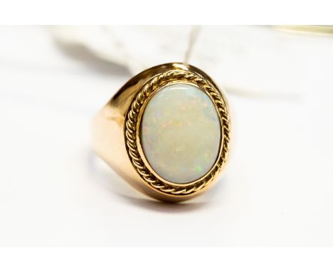 An opal and 9ct gold dress ring, oval opal approx 13mm x 10mm, rope border detail, size M1/2,  total gross weight 9.5 grams a