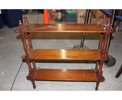 A late Victorian mahogany three tier What-not/wall shelf, each section raised on turned supports, 81 cms high, 85 cms wide, 1