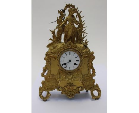 A late 19th century gilt metal, eight day mantle clock, in the Rococo revival style, white enamelled dial black Roman numeral