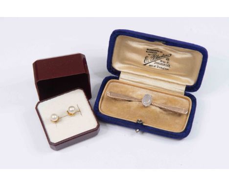 An unmarked rose metal and moonstone bar brooch, oval set moonstone set to the centre, along with a pair of 9ct gold and pear