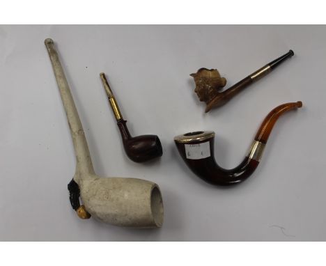 Pipe lot to include a pot Victorian novel pipe with football and boot decoration, Meereham female head pipe, silver mounted a