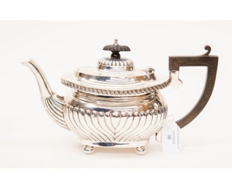 A silver teapot hallmarked in Birmingham 1919, probably Joseph Gloster (mark rubbed) having half fluting around the body and 