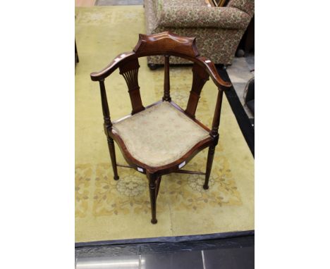 An Edwardian inlaid mahogany corner chair, with pierced splats and gold upholsterey