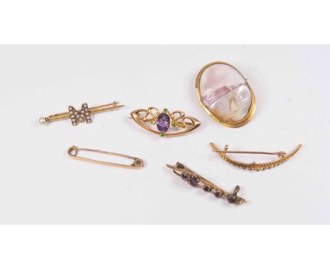 An Art Nouveau 15ct amethyst and green garnet brooch together with a Victorian seed pearl crescent brooch and a bar brooch se