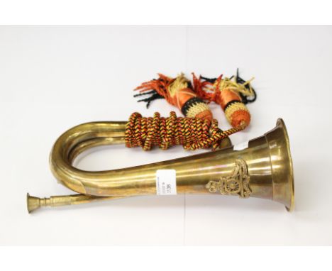 A brass military style Bugle with a Queens Crown Royal Artillery cap badge affixed. With mouth peice. No makers markings. Com