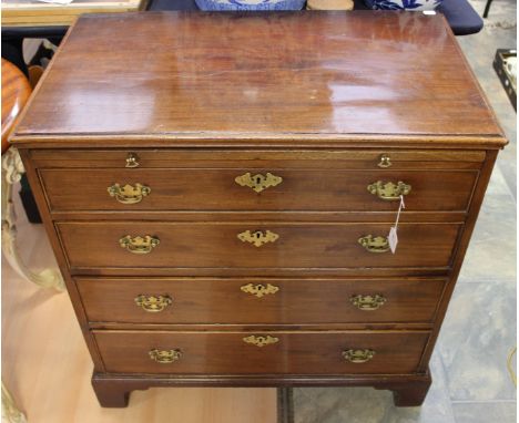 A George III mahogany chest of drawers, fitted with a brushing slide over four long graduated drawers, raised on bracket feet