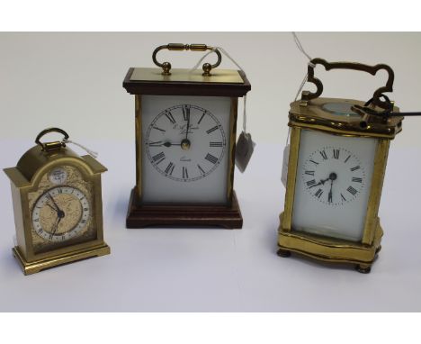 Brass skeleton movement mantle clock with Roman numerals, key is present together with two later mantle clocks, one quartz (3