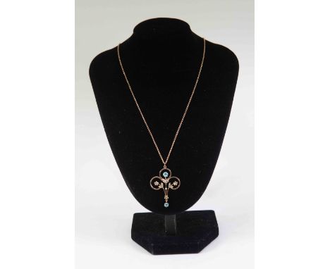 ****AUCTIONEER TO ANNOUNCE PASTE STONES  NOT AQUAMARINE****An Edwardian Art Nouveau 9ct gold openwork pendant, set with seed 