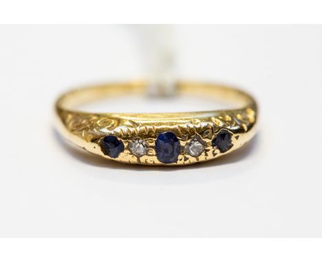 An 18ct gold, diamond and sapphire ring, scroll engraved shoulders, size N1/2, total gross weight approx 2.5gms