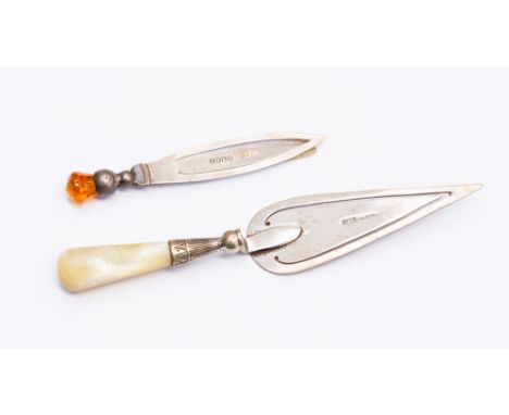 Two silver book marks comprising a trowel and thistle head