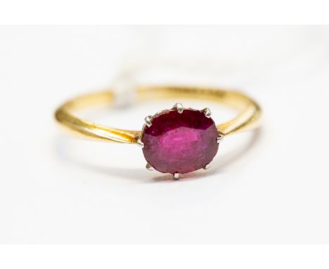 A synthetic ruby solitaire, the oval cut ruby approx 0.70ct, claw set in platinum with an 18ct gold shank, size M, total gros