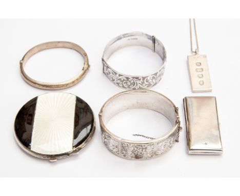 An Art Deco black and white guilloche enamel compact, Birmingham 1934, along with three silver bangles, a silver Ingot and si