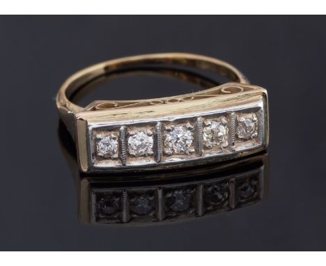 An Edwardian 18ct gold and diamond five stone ring, stamped 18ct the diamonds grain set in a row in a rectangular mount, head