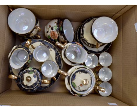 A Japanese egg shell porcelain tea service, each piece hand painted with flowers on a cream ground, with tea and coffee cups,