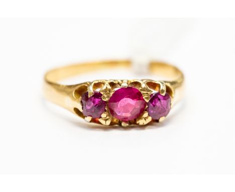 A ruby set dress ring, three graduated claw set round rubies set to the front, size L, total gross weight approx 2gms