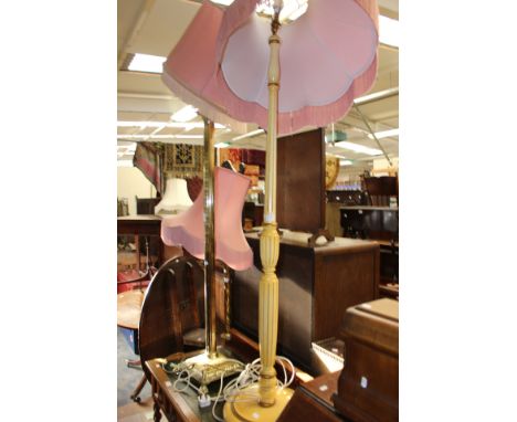Two brass and one wooden standard lamp.