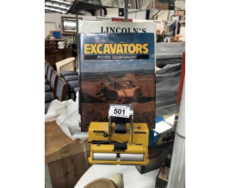 A model of Bomag roller and 2 books on excavators