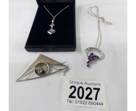 A 9ct white gold pendant with chain (approximately 3.4 grams), a hall marked silver 'eye' brooch together with a silver and a