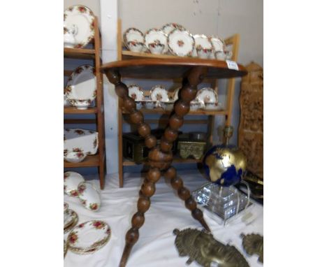 An oval tripod table on bobbin turned legs.
