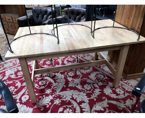 A pine extending dining table with chopping clock type top