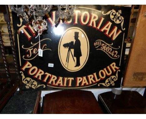 A painted sign "Victorian Portrait Parlour".