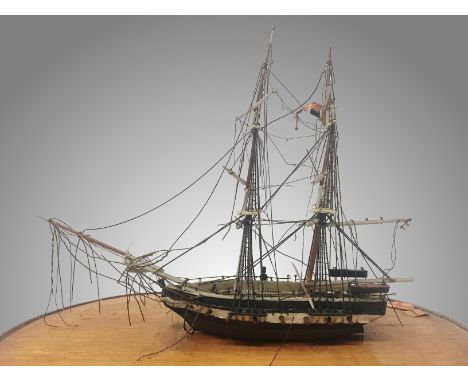 An antique model galleon under glass dome.