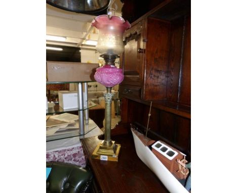 A Victorian brass Corinthian column oil lamp with later shade (font a/f).