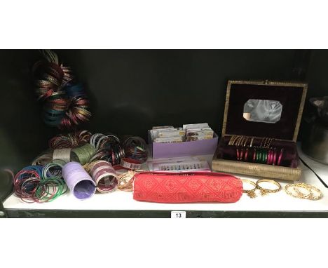 A shelf of decorative bangles and a quantity of face jewellery by Sweetgirl, Sitara etc.