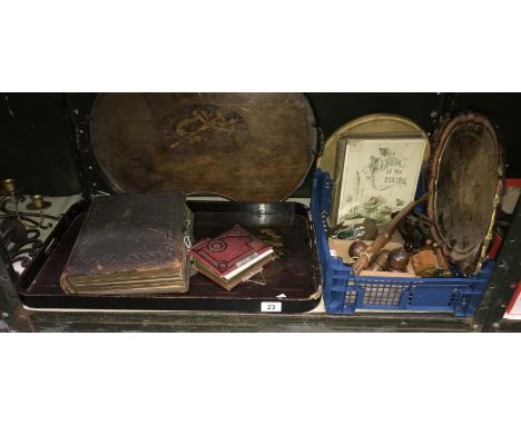 A shelf of wooden items and vintage photo albums etc.