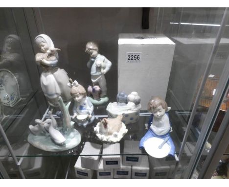 7 NAO figures including hen with chicks, dogs in basket, group of geese (boxed), girl holding lamb etc.,