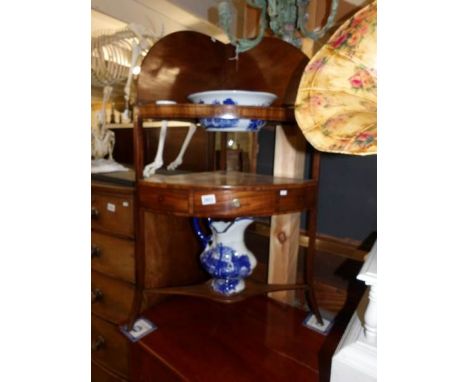 A Victorian mahogany corner washstand with modern blue and white jug and basin set.
