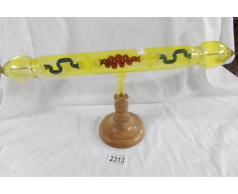 An unusual glass item on stand for a purpose not known.