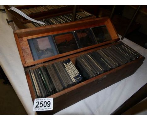 A wooden box containing approximately 110 black and white glass lantern slides, subjects include Queen Victoria's Diamond Jub