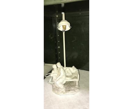 A figural table lamp