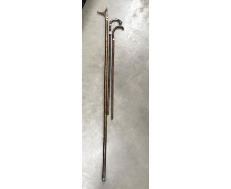 A walking stick with ball and claw handle and silver collar, a thumb stic with antler handle featuring inlaid bullet and 1 ot