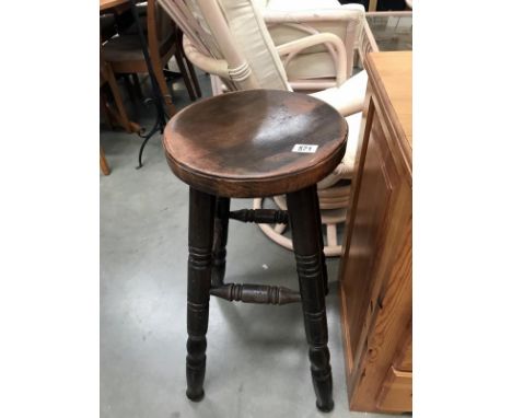 A wooden bar/kitchen stool
