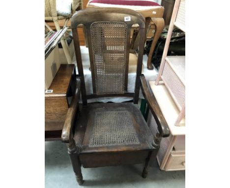 An Edwardian mahogany carver chair commode with bergiere seat and back panels