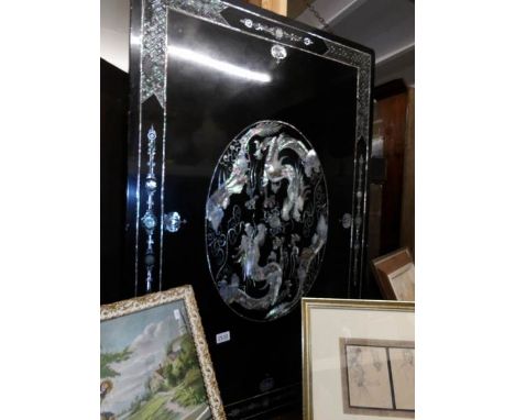 An oriental black lacquer and mother of pearl table top converted to a wall hanging.