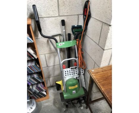 A quantity of garden tools including scarifier, rotavator, bulb planter, spade, fork and stool