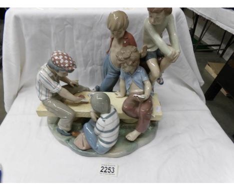A large NAO by Lladro tableau piece of boys playing cards.