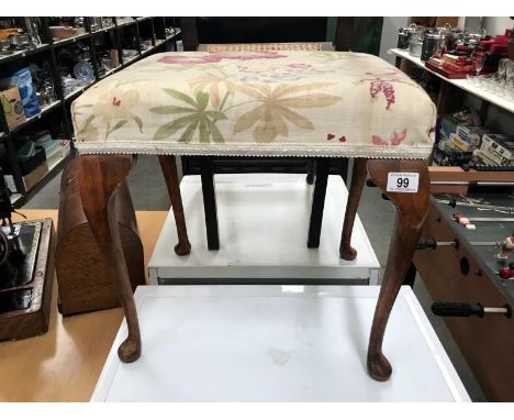 A dressing table stool on pad feet