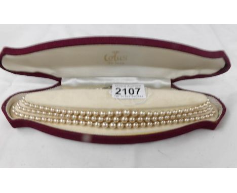 A cased 3 strand pearl necklace with silver clasp.