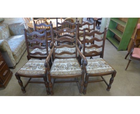 A set of six oak framed ladder back chairs, four and two carvers with drop in seats raised on turned supports joined by stret