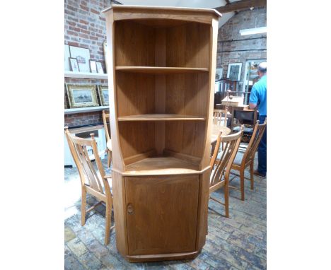 An Ercol Elm corner cupboard - in good condition