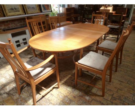 A modern Ercol light oak extending dining table with  six chairs including two carvers - 160cm/210cm x 107cm wide - in good c