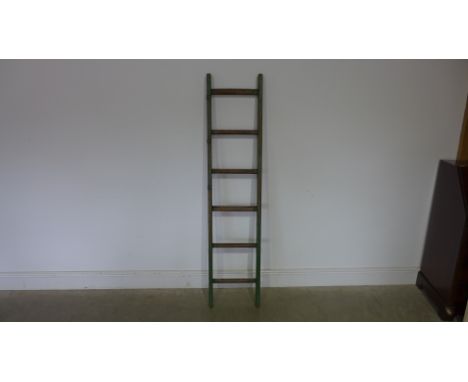 A six rung ladder with original green paint - waxed for decorative use - 159cm x 35cm 