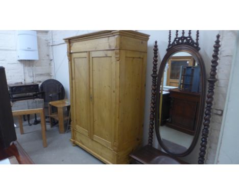 A compact 19th century stripped pine two door wardrobe of good quality - fully sectional with original wooden coat hooks - He